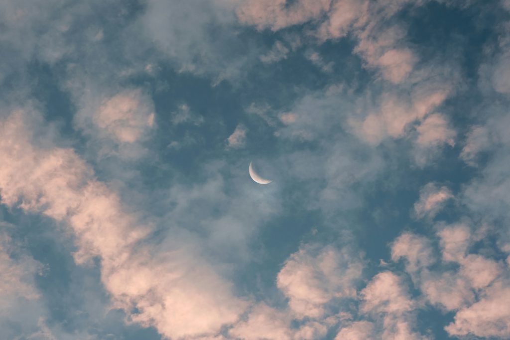 A crescent moon in a soft cloudy sky to represent the cycles we move through in life and how our boundaries can change through different phases